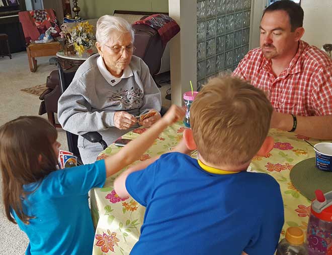 Great Grandma playing Uno with the kids