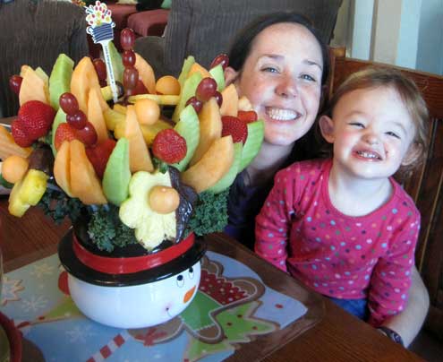 Kim and Chloe are excited about the Edible Fruit Arrangement grandma ordered for them