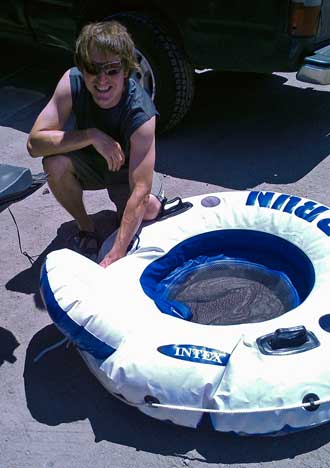 Scott is inflating the tubes for a float down the Truckee River