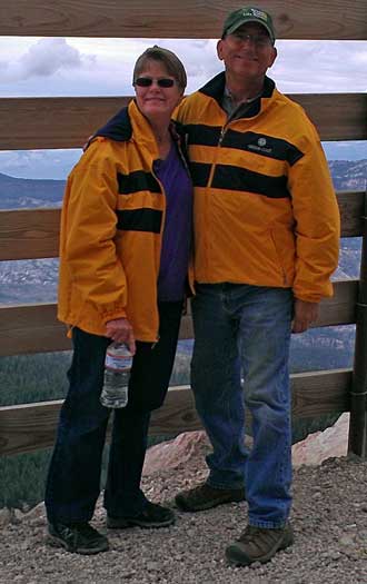 Dale and Gwen and the top in matching Oregon Coast jackets; Behind: Trail map of Mammoth Mountain bicycle trails