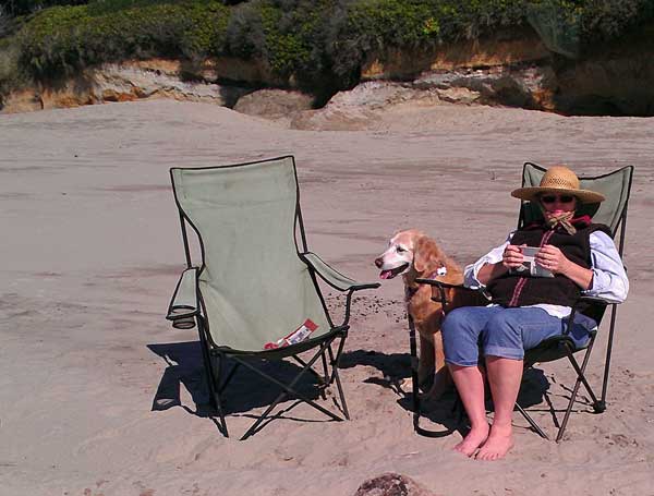 Gwen enjoying the Tillicum beach, Behind: Dale rests after flying his parafoil kite