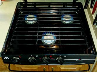 The stove top purchased with the Alumascape, Behind: The new range is installed