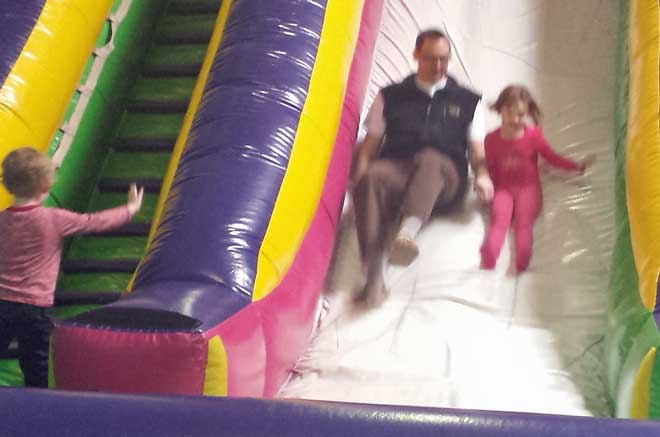 Chloe and Dad on the bouce slide, Noah climbing