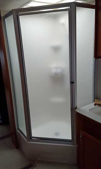 A glass shower is nice in a small trailer