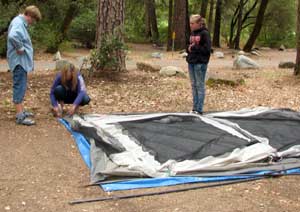 Gwen, Courtney and Lesa start to assemble a tent in our back yard