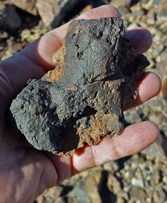 At the top, collecting a rock from the top