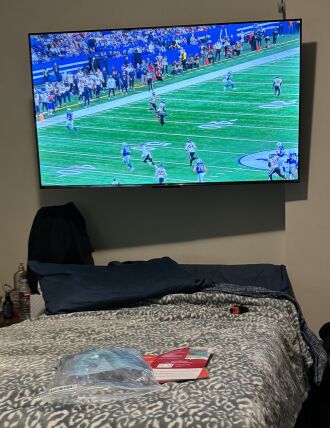 55" TV mounted over the bed