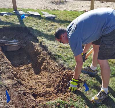 Ben is digging a hole in the backyard