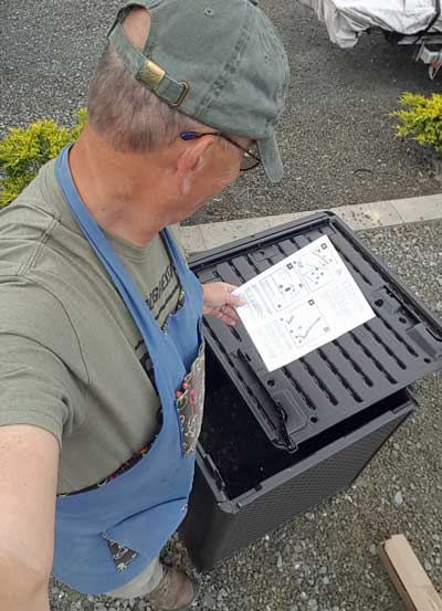 Reading the instructions to assemble the water house.