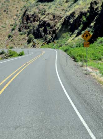 The road winds through the mountain gorges