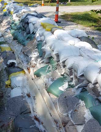 Evidence of flooding, sand bags to protect the neighborhood