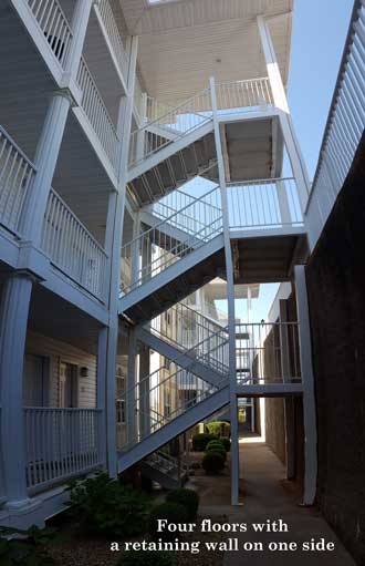 Four story building next to the retaining wall