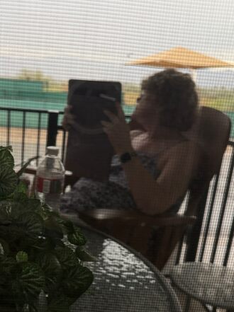 Gwen enjoying the rain while sitting on our deck