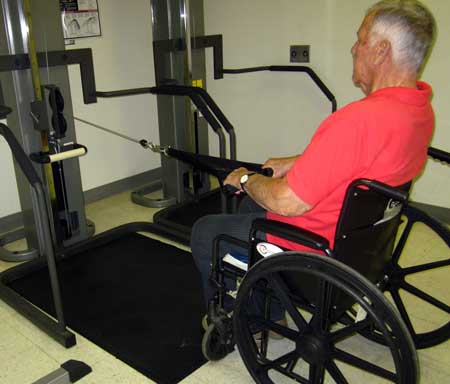 Dad using a machine to exercise his arm