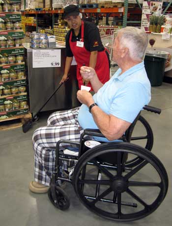 Dad is enjoying a free food sample at Costco