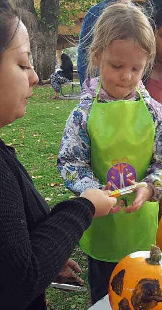 Lucy painting a pumpkin