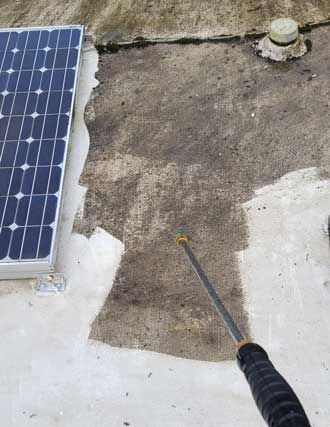 Using a pressure washer to clean the scum