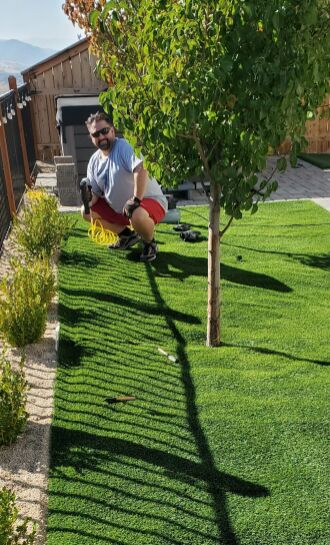 Using a pneumatic staple gun to anchor the grass