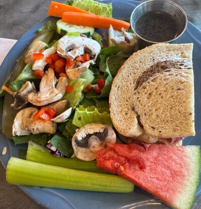 1/2 corned beef sandwich with side salad and poppy seed dressing