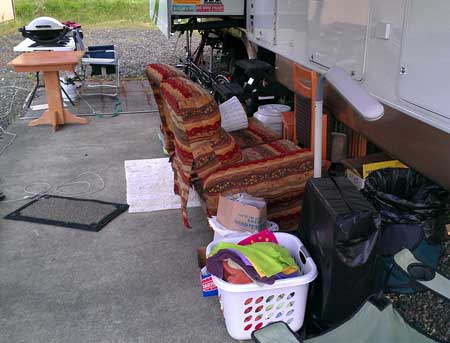 Furniture piled outside in preparation for recarpeting the living room