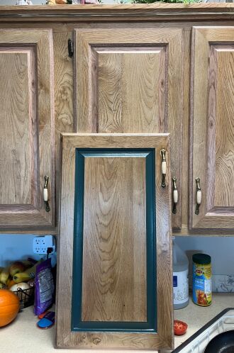 Green trim matches the green lower cabinets