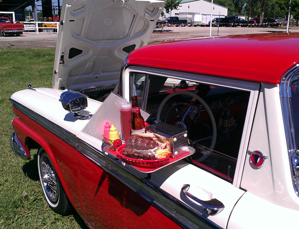 Eating at a drive up diner in a vintage Ford