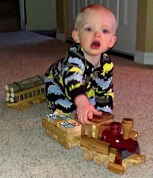 Noah makes train noises as he pushes his yard engine