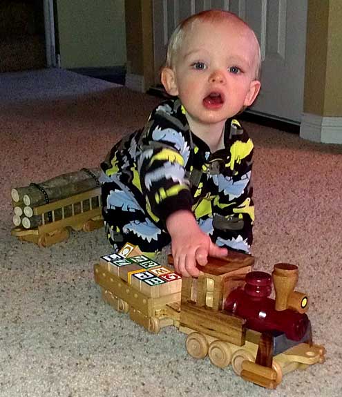 Noah makes train noises as he pushes his yard engine