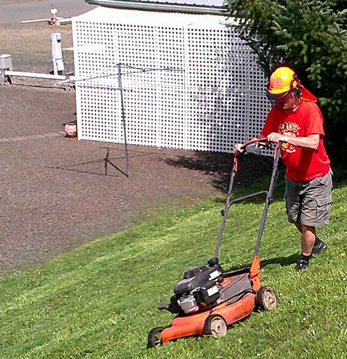 Mowing a portion of the park which can't be mowed by the riding mower