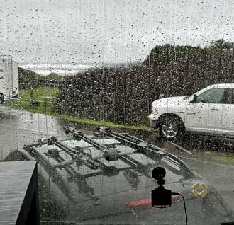 Watching the ocean through a rain covered windshield