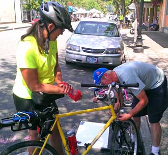 Dave give free bike repair, Behind: Cool off in the water tunnel