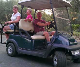 Janet and Ralph greet us at Park Sierra; Behind: Our space at the park, #330 with deck and lots of shade trees