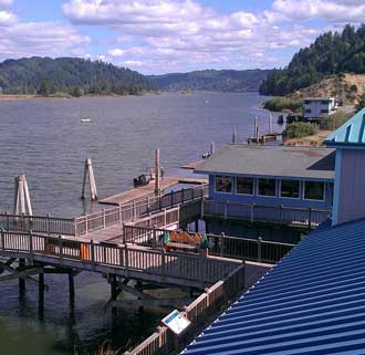 Looking upstream on the Umpqua River, Behind: Looking downstream and at the cafe where we got drinks on a warm afternoon. 