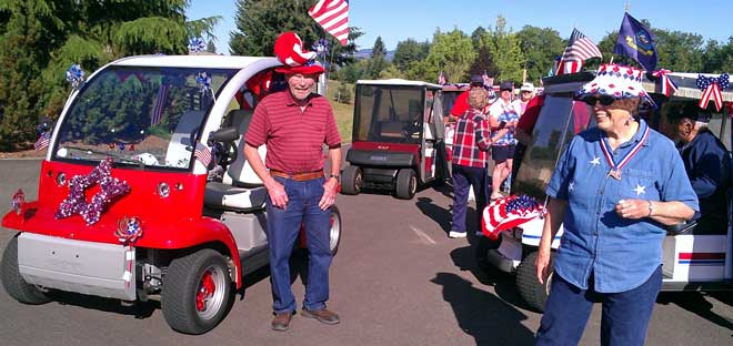 Preparing for the Independence Day golf cart parade, Behind: It's a Timber Valley tradition