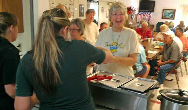 Theresa is really happy with her breakfast at the Chapter 9 meeting, Behind: Helaine is recording the Chapter 9 breakfast in the clubhouse