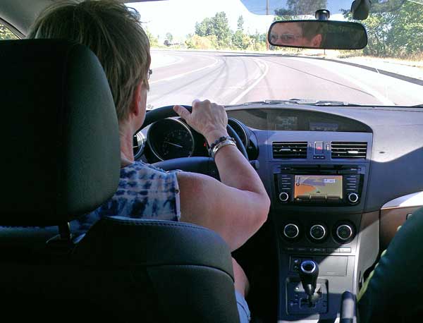 Gwen test drives a Mazda 3, Behind: Total "fun-factor" vehicle, worthless as anything else