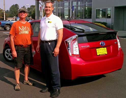 Dale with Will Baas handing over the car, Behind: The Prius engine