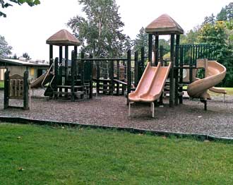 Kids play equipment at River Forks, Behind: Picnic pavilion