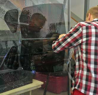 John separates the precut images, Behind: tint must be fit to curved glass