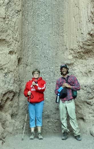 Gwen with Eric, the hitchhiker she picked up, Behind: Gwen and Dale with the dry fall in Natural Bridge canyon