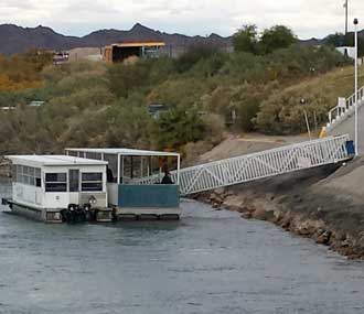 The free boat to cross the Colorado River from Arizona to Nevada for the casinos, Behind: The Riverside in Laughlin, Nevada