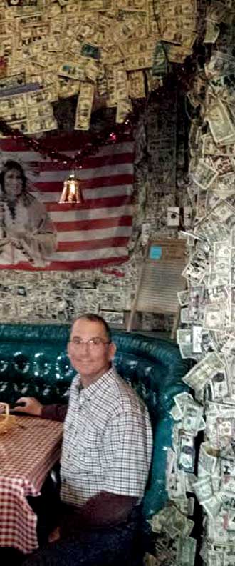 In our Oatman Hotel booth with our dollar overhead, Behind: Live music at the Oatman, dollars everywhere