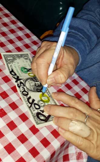 Decorating our own dollar to leave behind, Behind: Hanging over our booth