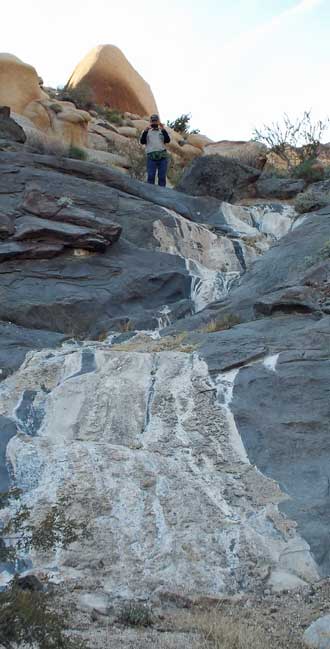 Return via the water route, Behind: Eric finds a story in the rocks.