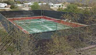 A single tennis court, Behind: miniature golf