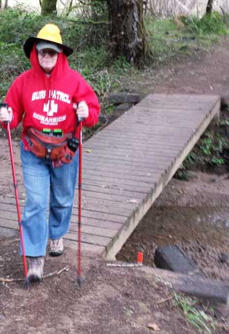 Gwen hiking the Cooper Creek Reservoir Trail, Behind: What fish are in this lake?