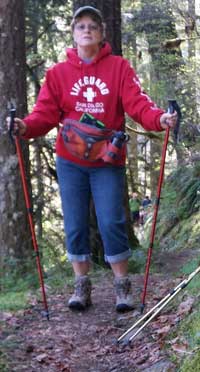 Gwen on the trail, Behind: wild ginger blossom