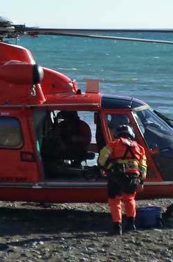 The crew gets the helicopter ready for take-off