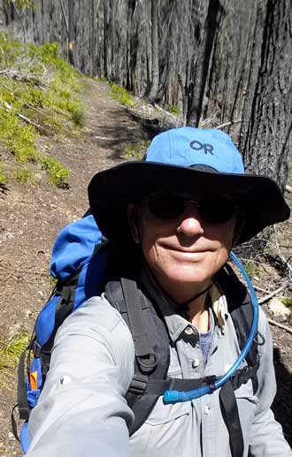 I'm hiking along the trail, Behind: The hiking group at Whitehorse Meadows for lunch.