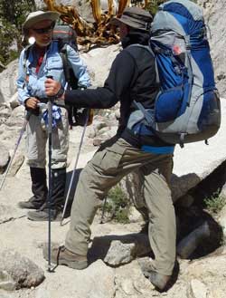 Merle and Katchan discussing the trail, Behind: still climbing toward Kersarge Pass